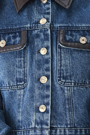 A model wearing a blue denim jacket with dark brown leather-look trim details on the collar | FREEMARKET