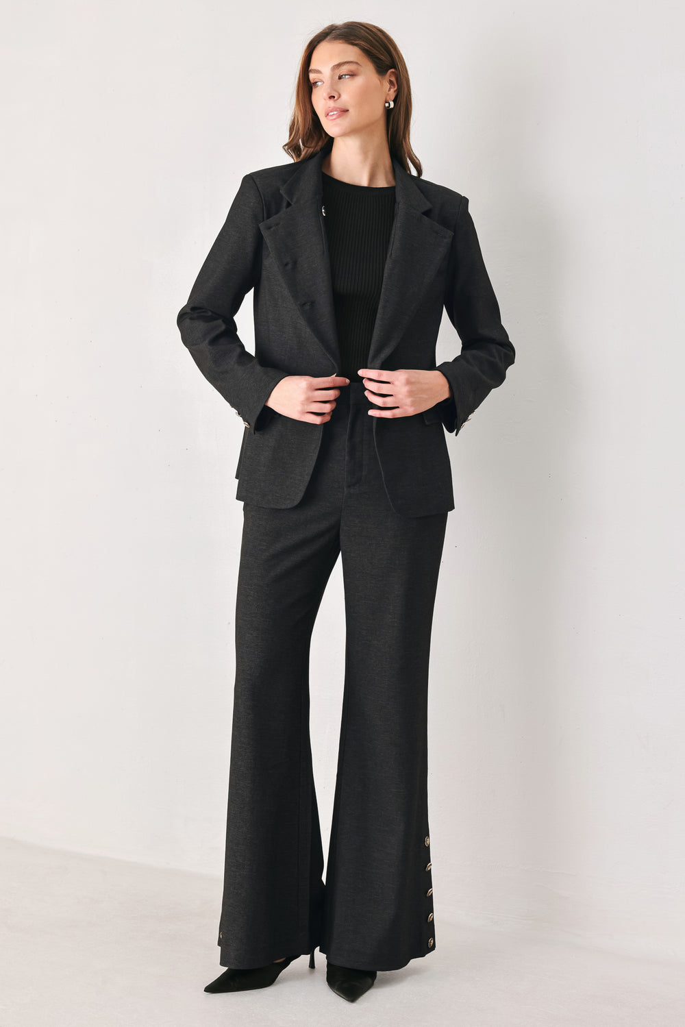 Woman wearing a black blazer military jacket with three buttons and faux pockets | FREEMARKET