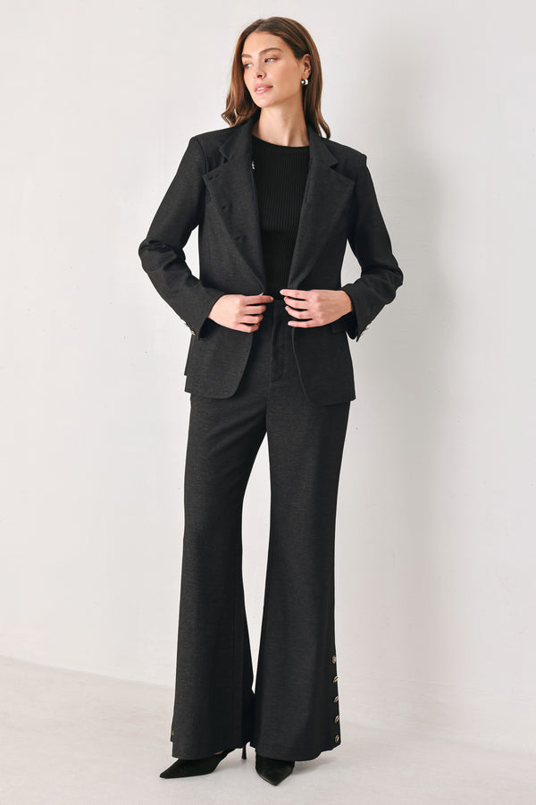 Woman wearing a black blazer military jacket with three buttons and faux pockets | FREEMARKET