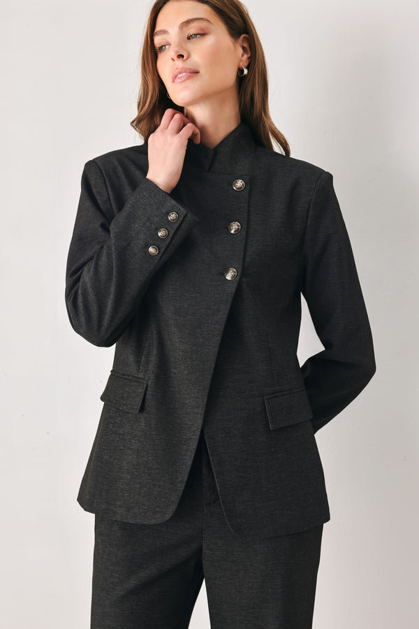 Woman wearing a black blazer military jacket with three buttons and faux pockets | FREEMARKET