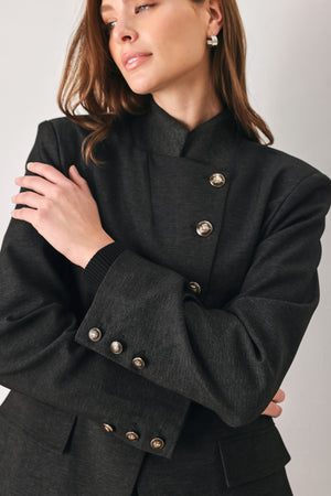Woman wearing a black blazer military jacket with three buttons and faux pockets | FREEMARKET