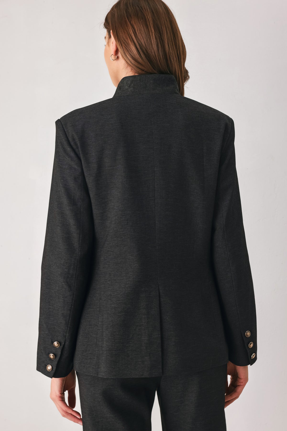 Woman wearing a black blazer military jacket with three buttons and faux pockets | FREEMARKET