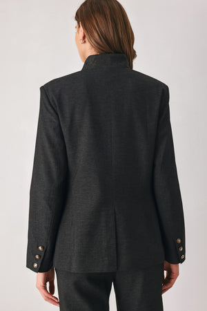 Woman wearing a black blazer military jacket with three buttons and faux pockets | FREEMARKET