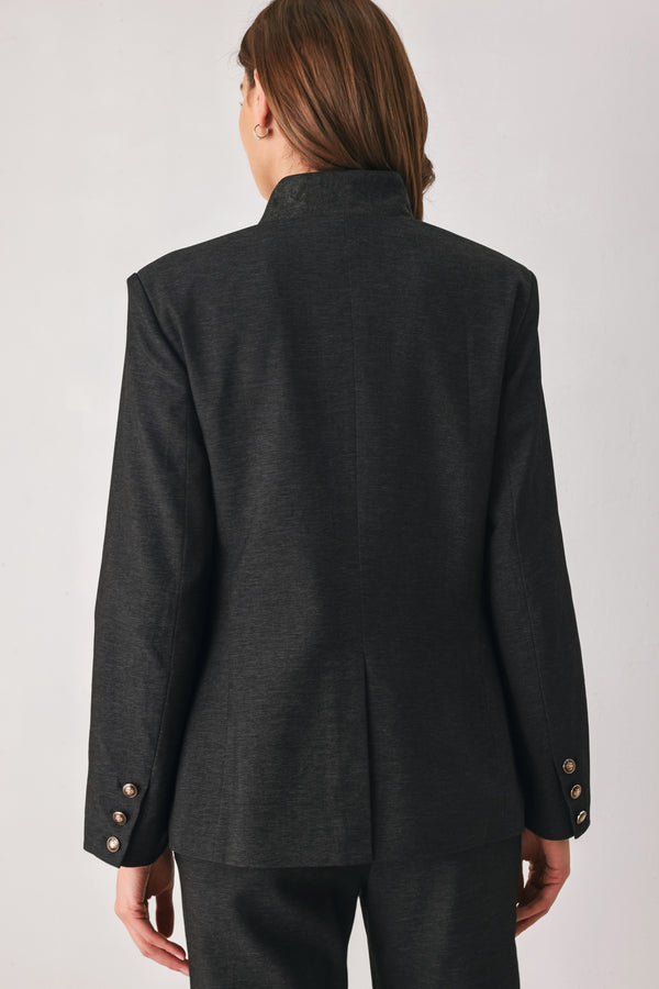Woman wearing a black blazer military jacket with three buttons and faux pockets | FREEMARKET