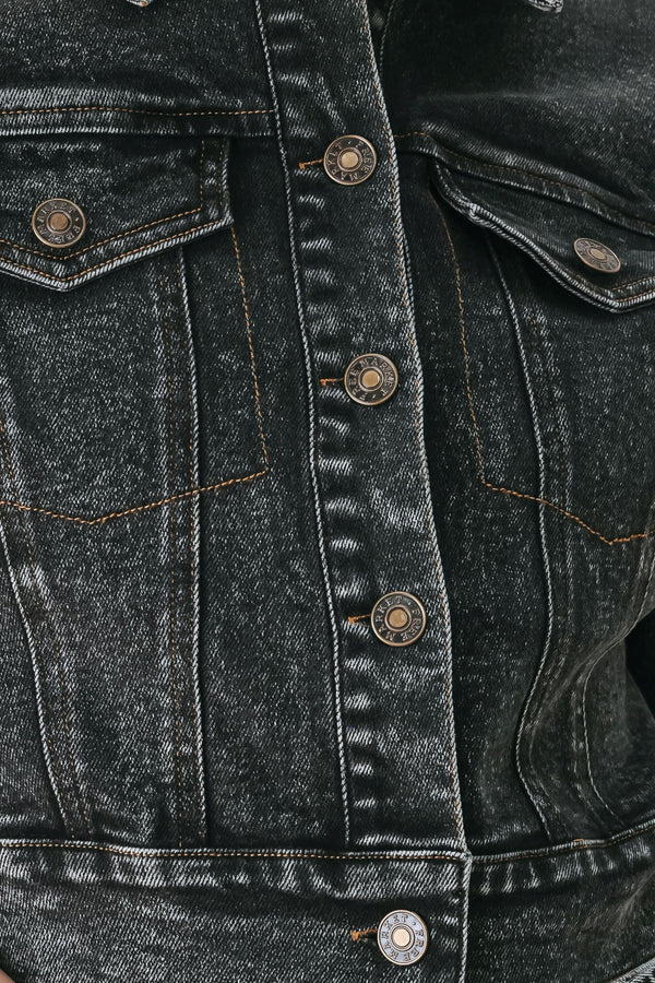 A model wearing a cropped, short-sleeved black acid-wash denim jacket with a band collar and button front | FREEMARKET