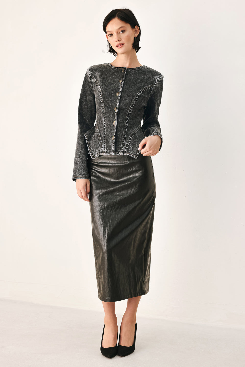A model wearing a dark gray washed denim jacket with decorative button details down the front | FREEMARKET