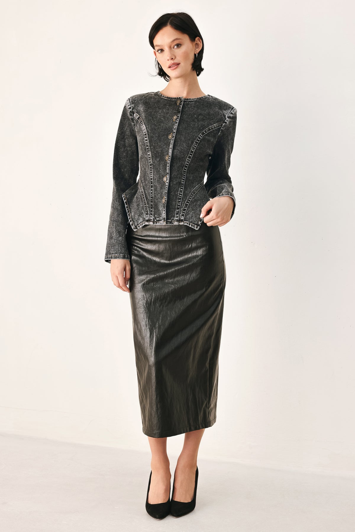A model wearing a dark gray washed denim jacket with decorative button details down the front | FREEMARKET