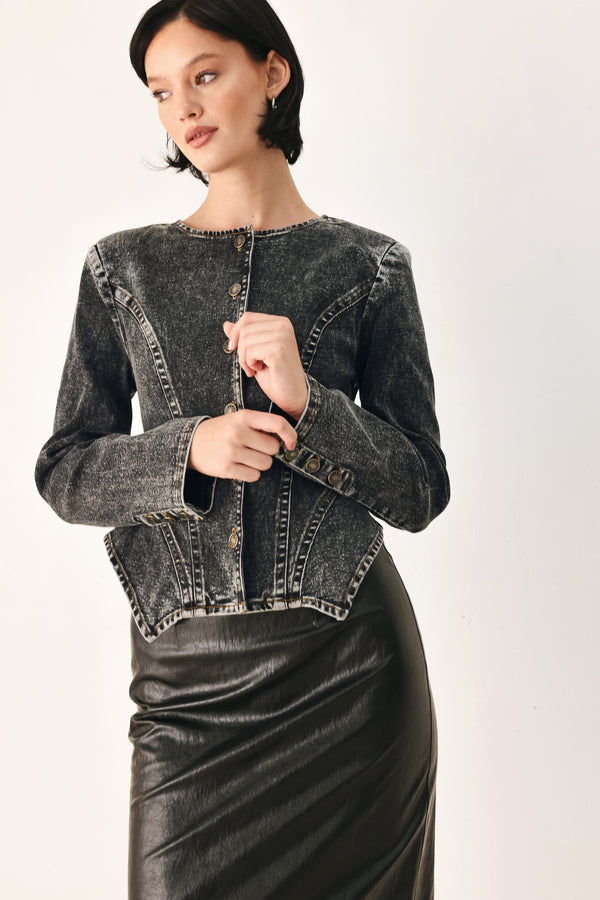 A model wearing a dark gray washed denim jacket with decorative button details down the front | FREEMARKET