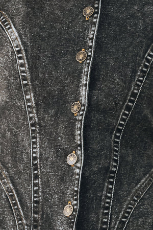 A model wearing a dark gray washed denim jacket with decorative button details down the front | FREEMARKET