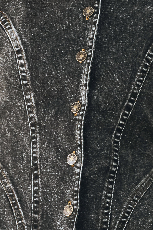 A model wearing a dark gray washed denim jacket with decorative button details down the front | FREEMARKET