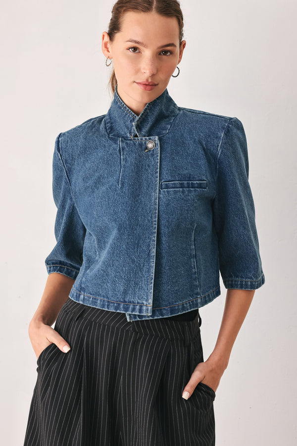 A woman wearing a cropped blue denim jacket with a high stand collar, structured shoulders, and elbow-length sleeves | FREEMARKET