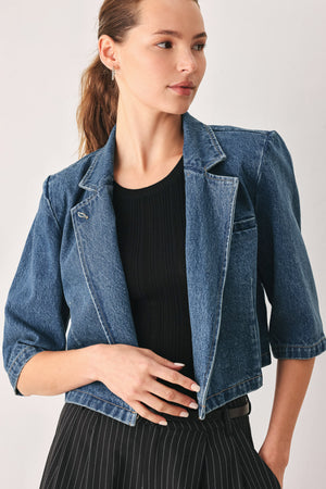 A woman wearing a cropped blue denim jacket with a high stand collar, structured shoulders, and elbow-length sleeves | FREEMARKET