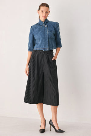 A woman wearing a cropped blue denim jacket with a high stand collar, structured shoulders, and elbow-length sleeves | FREEMARKET