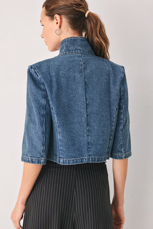 A woman wearing a cropped blue denim jacket with a high stand collar, structured shoulders, and elbow-length sleeves | FREEMARKET