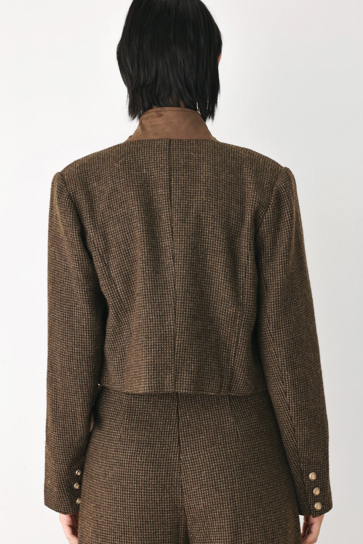 A model wearing a brown textured tweed jacket with a contrasting solid brown collar and decorative gold-tone buttons | FREEMARKET