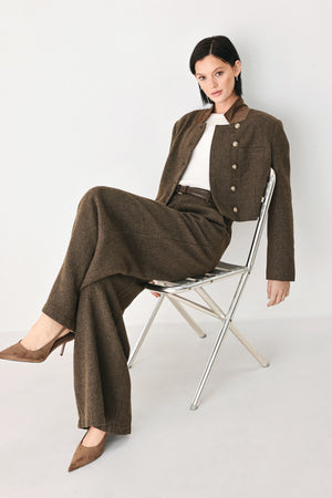 A model wearing a brown textured tweed jacket with a contrasting solid brown collar and decorative gold-tone buttons | FREEMARKET