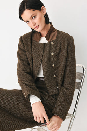 A model wearing a brown textured tweed jacket with a contrasting solid brown collar and decorative gold-tone buttons | FREEMARKET