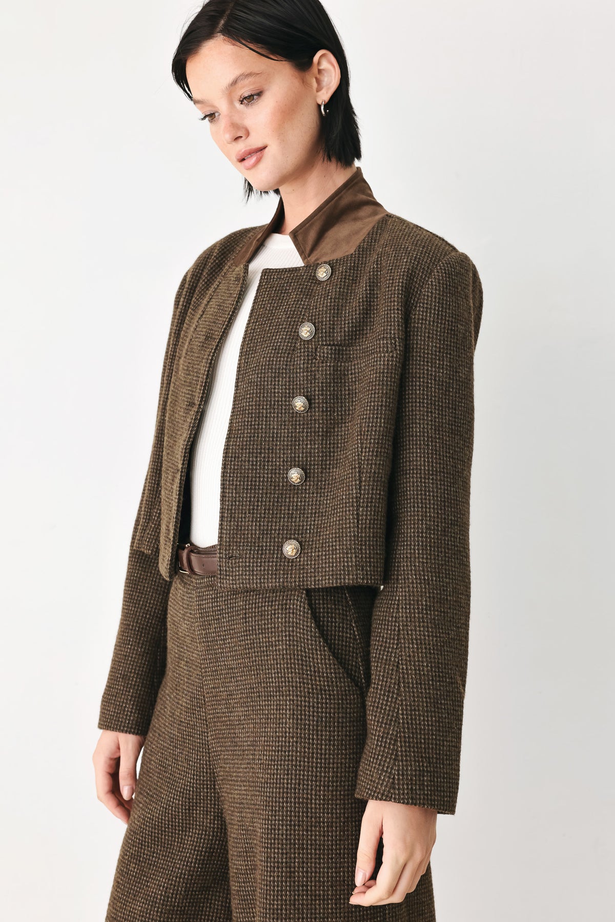 A model wearing a brown textured tweed jacket with a contrasting solid brown collar and decorative gold-tone buttons | FREEMARKET