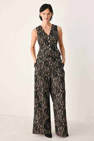 A woman wearing a sleeveless black lace vest with a V-neckline, front buttons | FREEMARKET