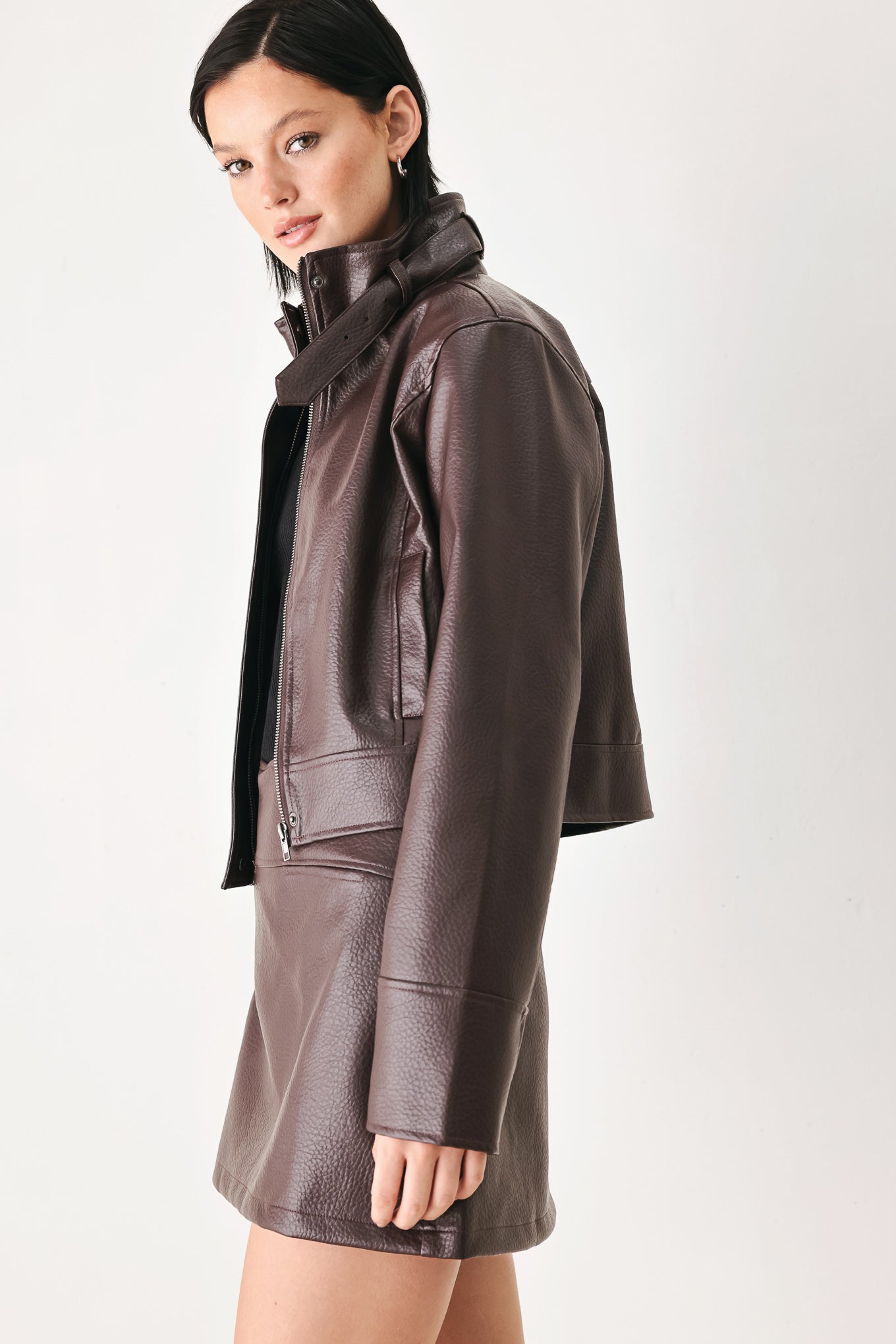 A model wearing a dark brown faux-leather jacket | FREEMARKET