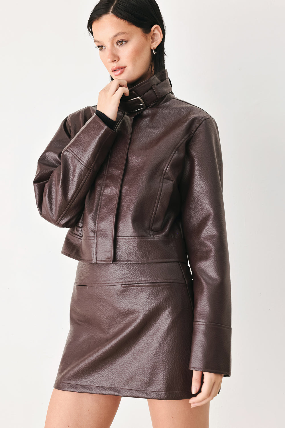 A model wearing a dark brown faux-leather jacket | FREEMARKET