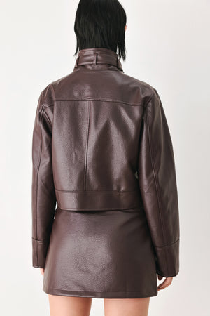 A model wearing a dark brown faux-leather jacket | FREEMARKET