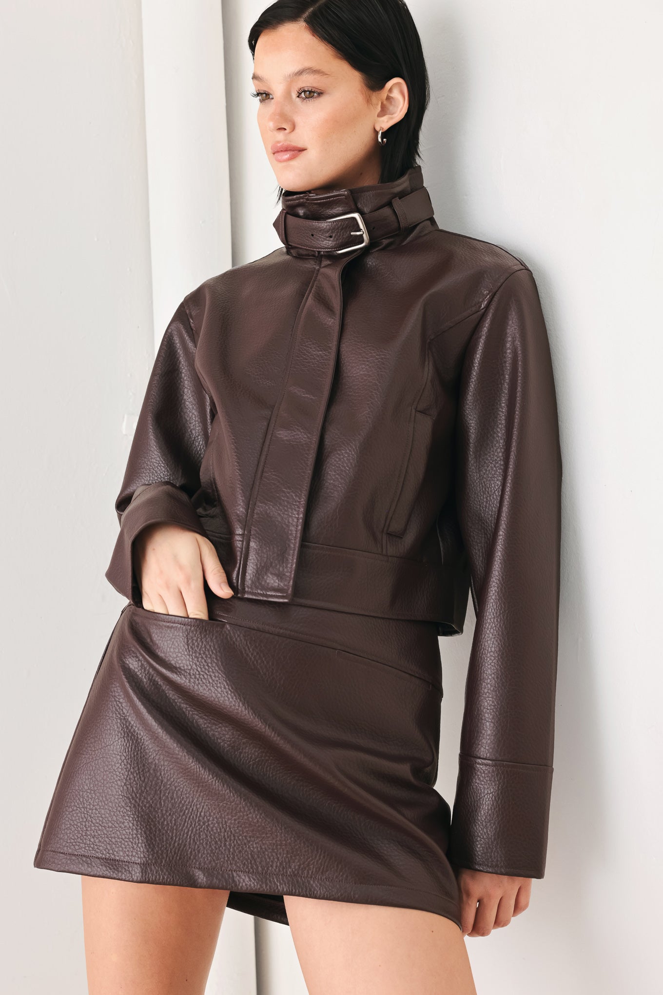 A model wearing a dark brown faux-leather jacket | FREEMARKET