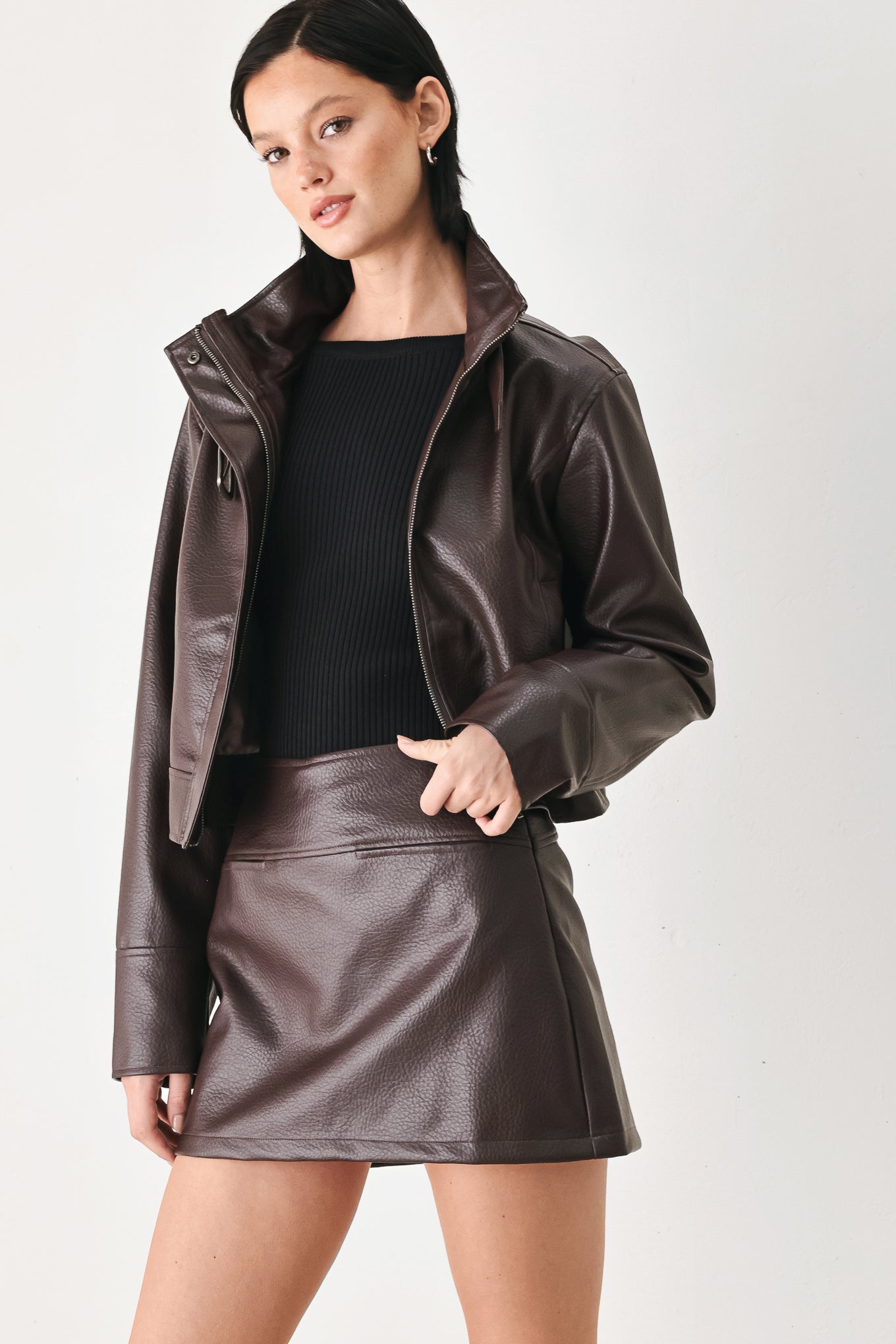 A model wearing a dark brown faux-leather jacket | FREEMARKET