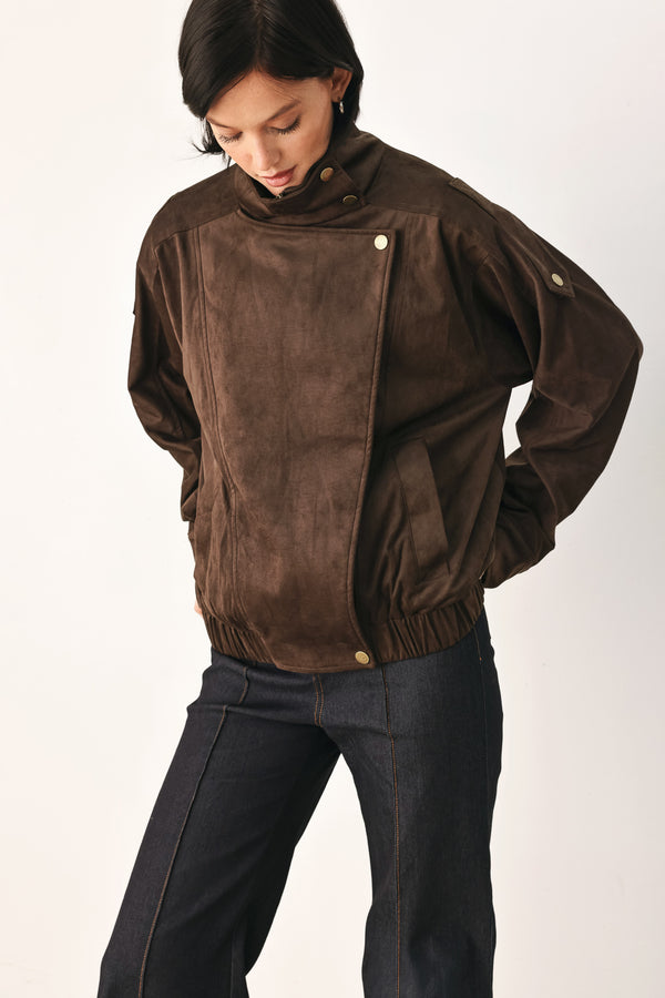 A woman wearing a dark brown suede jacket with a high collar and gold-tone snap buttons | FREEMARKET