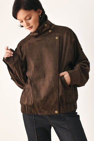 A woman wearing a dark brown suede jacket with a high collar and gold-tone snap buttons | FREEMARKET