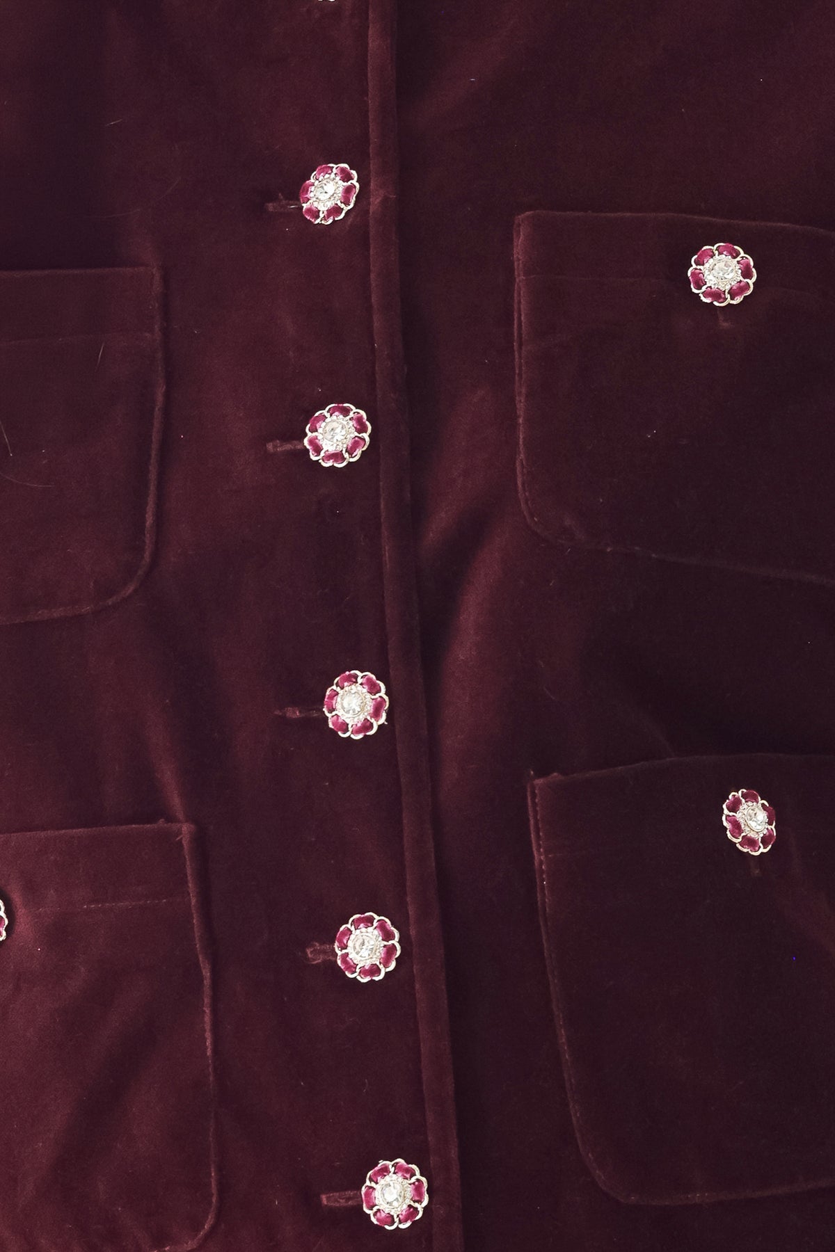 Woman wearing a burgundy long sleeve cropped jacket with buttons along the front center and on four front pockets | FREEMARKET