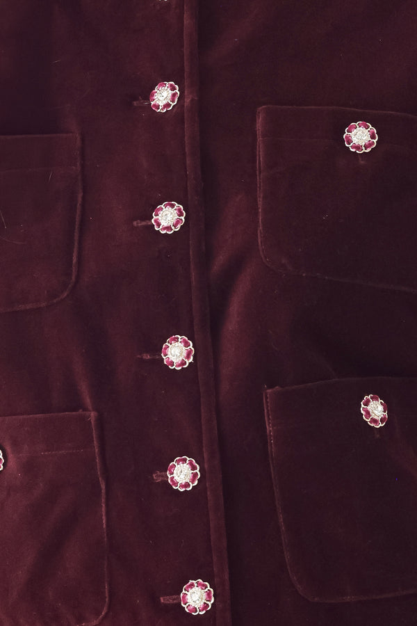 Woman wearing a burgundy long sleeve cropped jacket with buttons along the front center and on four front pockets | FREEMARKET
