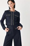 A model wearing a dark indigo denim jacket featuring gold chain trim details on the collar, chest pockets | FREEMARKET