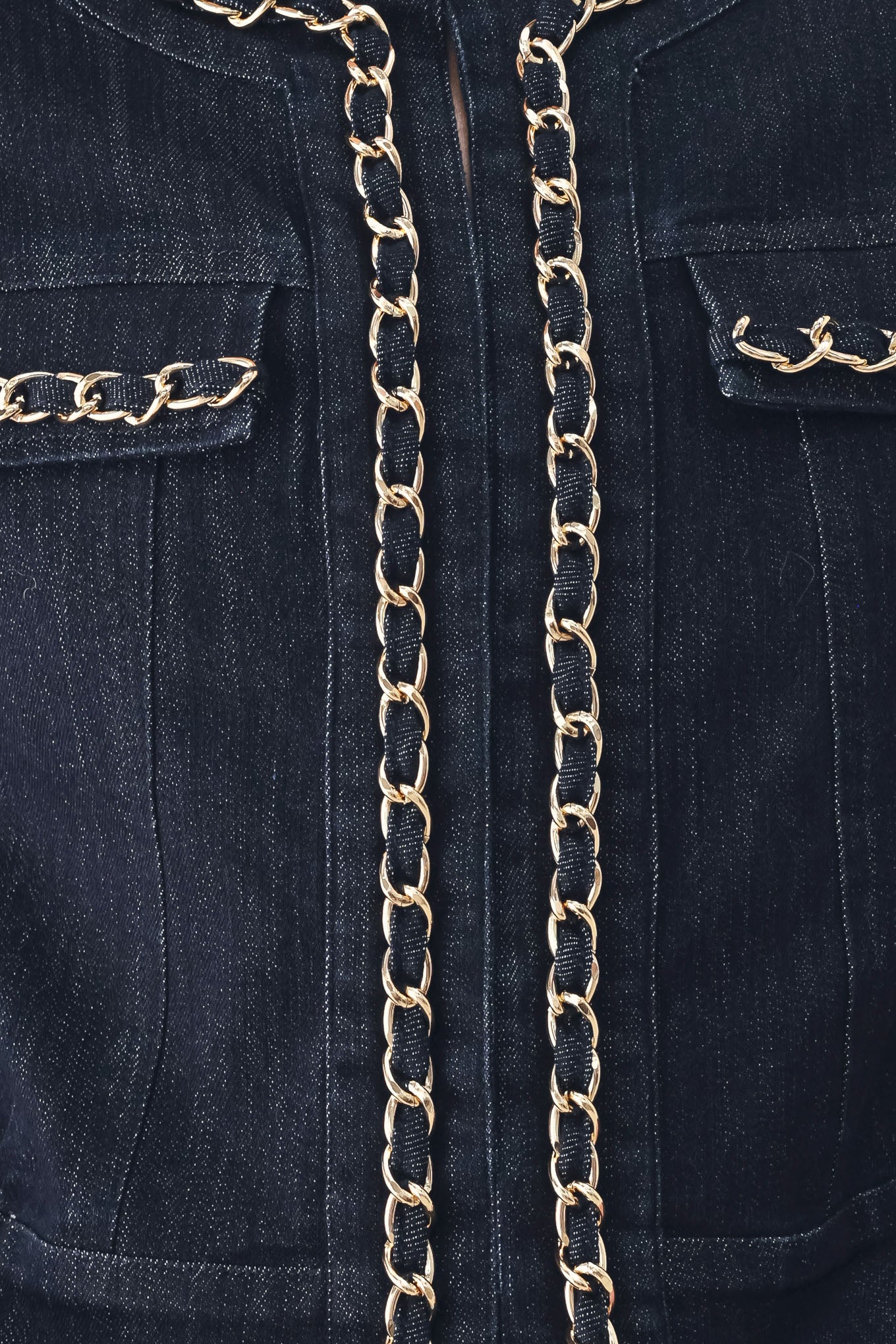 A model wearing a dark indigo denim jacket featuring gold chain trim details on the collar, chest pockets | FREEMARKET