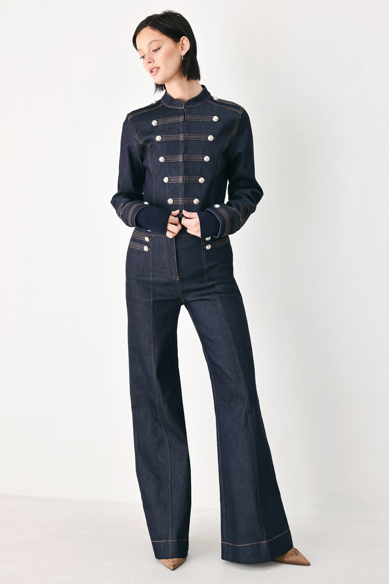 A model wearing a dark indigo denim military-style jacket with double-breasted silver buttons | FREEMARKET