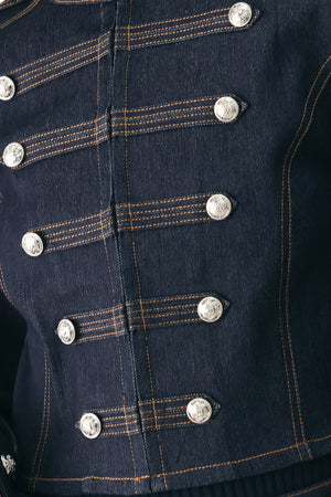 A model wearing a dark indigo denim military-style jacket with double-breasted silver buttons | FREEMARKET