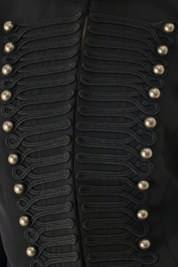 Woman wearing a long-sleeve mock neck black cropped jacket top with double breasted buttons and military style braiding | FREEMARKET