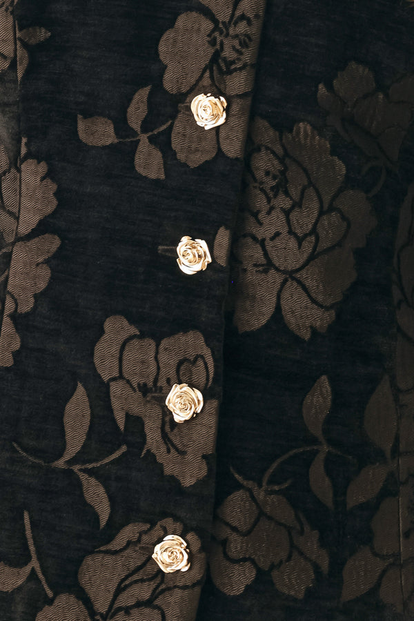 Woman wearing a short sleeve v-neck black top with brown jacquard floral pattern | FREEMARKET