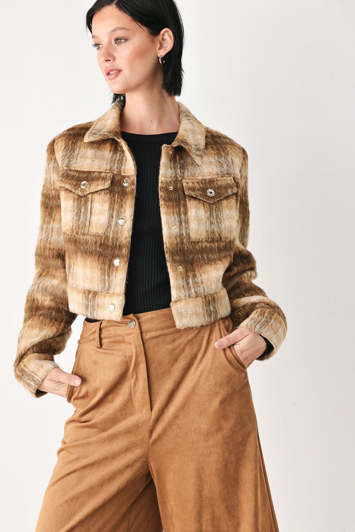 A woman models a cropped, long-sleeve plaid jacket in brown and beige tones | FREEMARKET