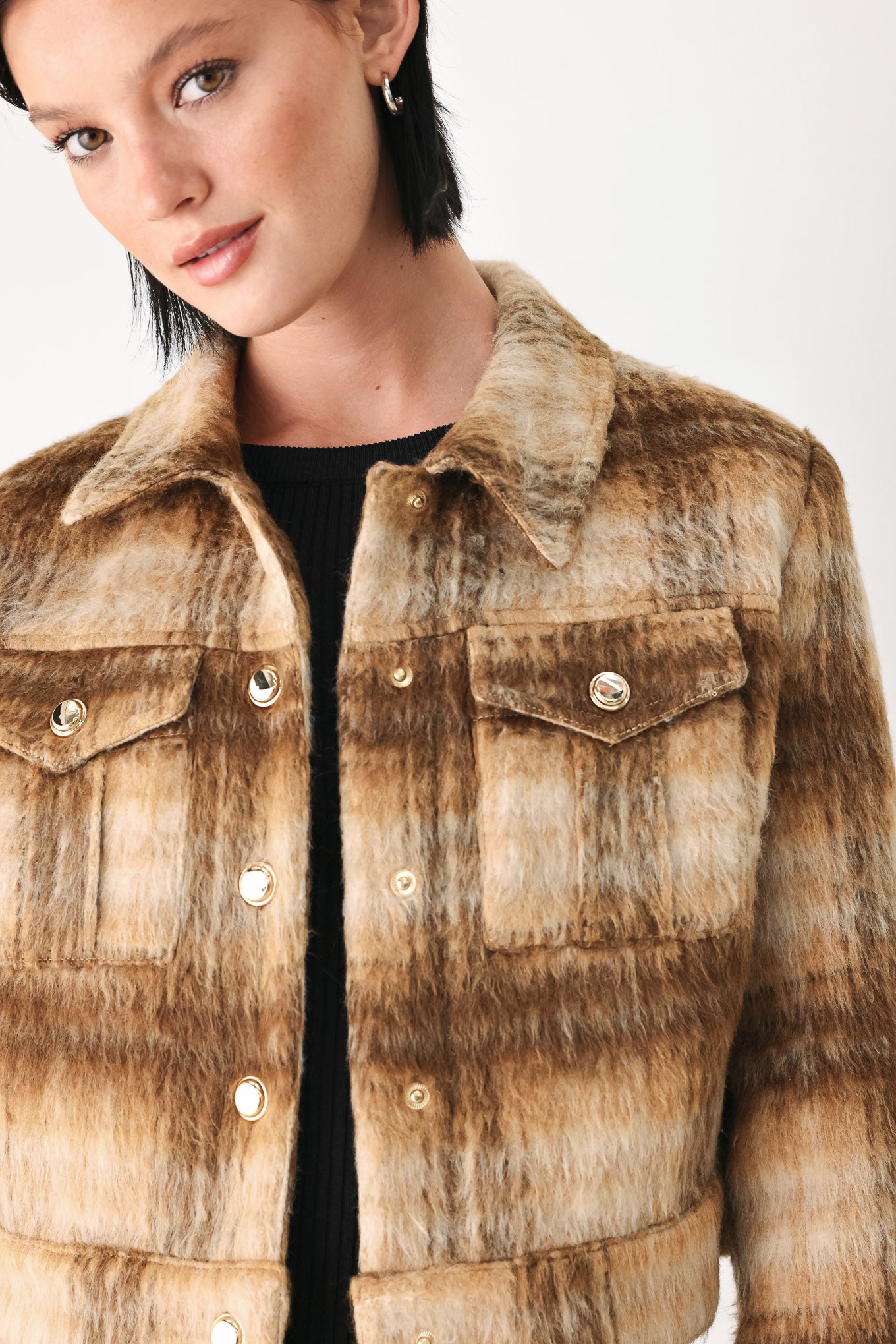 A woman models a cropped, long-sleeve plaid jacket in brown and beige tones | FREEMARKET