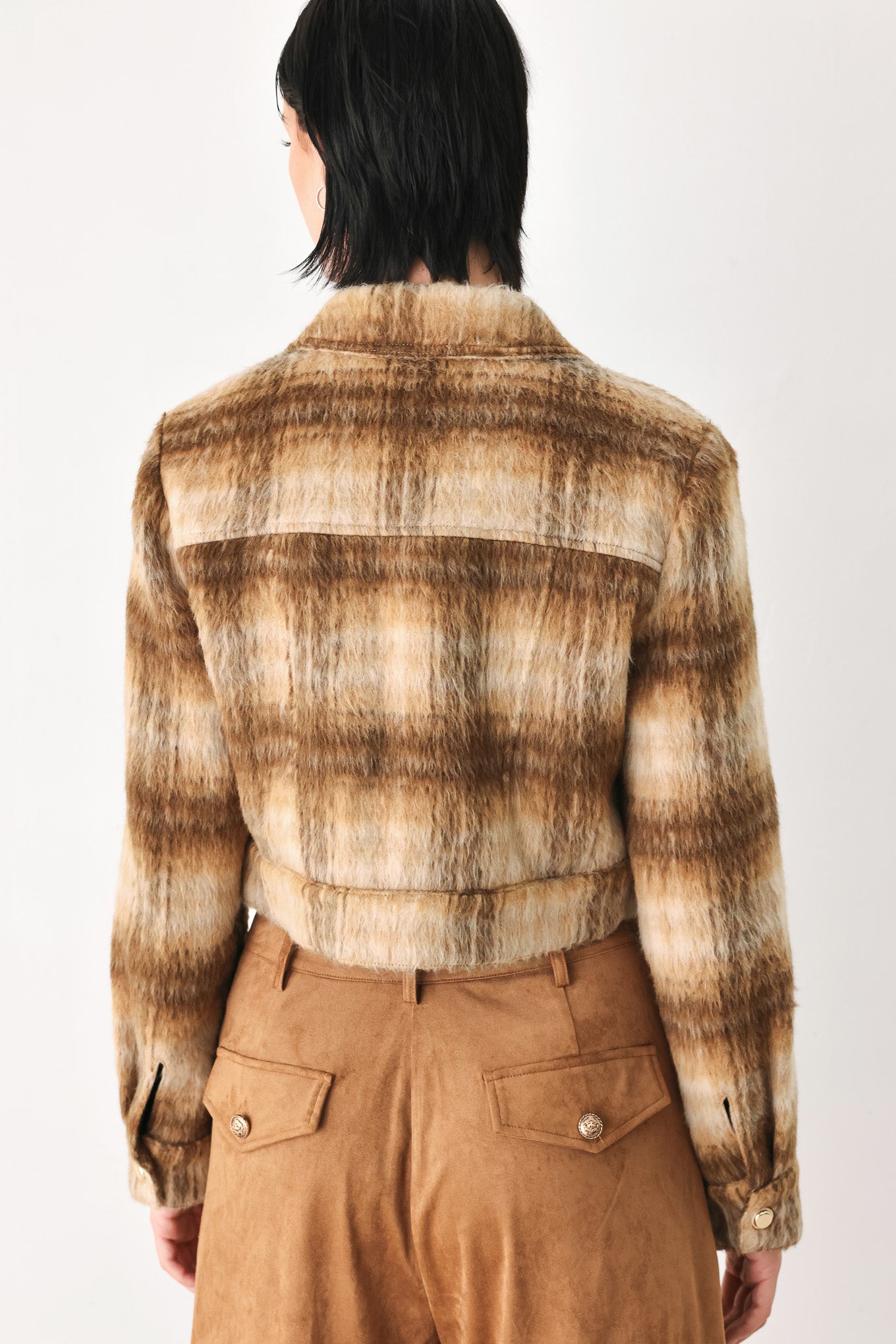 A woman models a cropped, long-sleeve plaid jacket in brown and beige tones | FREEMARKET