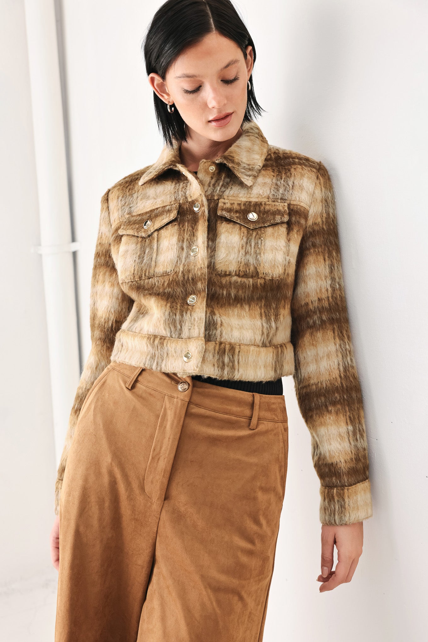 A woman models a cropped, long-sleeve plaid jacket in brown and beige tones | FREEMARKET