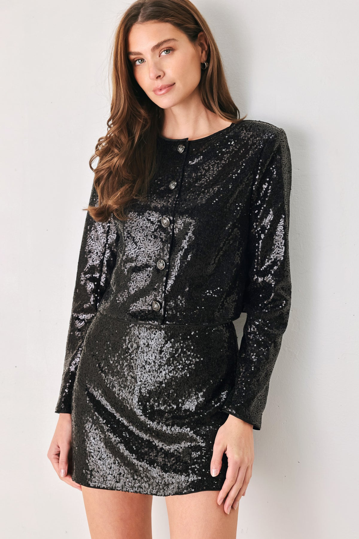 A woman modeling a black long-sleeve cropped jacket covered in sequins, featuring a buttoned front | FREEMARKET