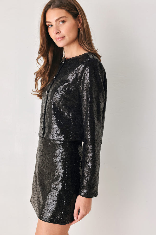 A woman modeling a black long-sleeve cropped jacket covered in sequins, featuring a buttoned front | FREEMARKET