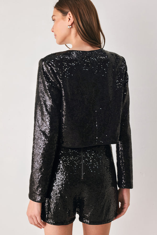 A woman modeling a black long-sleeve cropped jacket covered in sequins, featuring a buttoned front | FREEMARKET