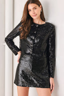 A woman modeling a black long-sleeve cropped jacket covered in sequins, featuring a buttoned front | FREEMARKET