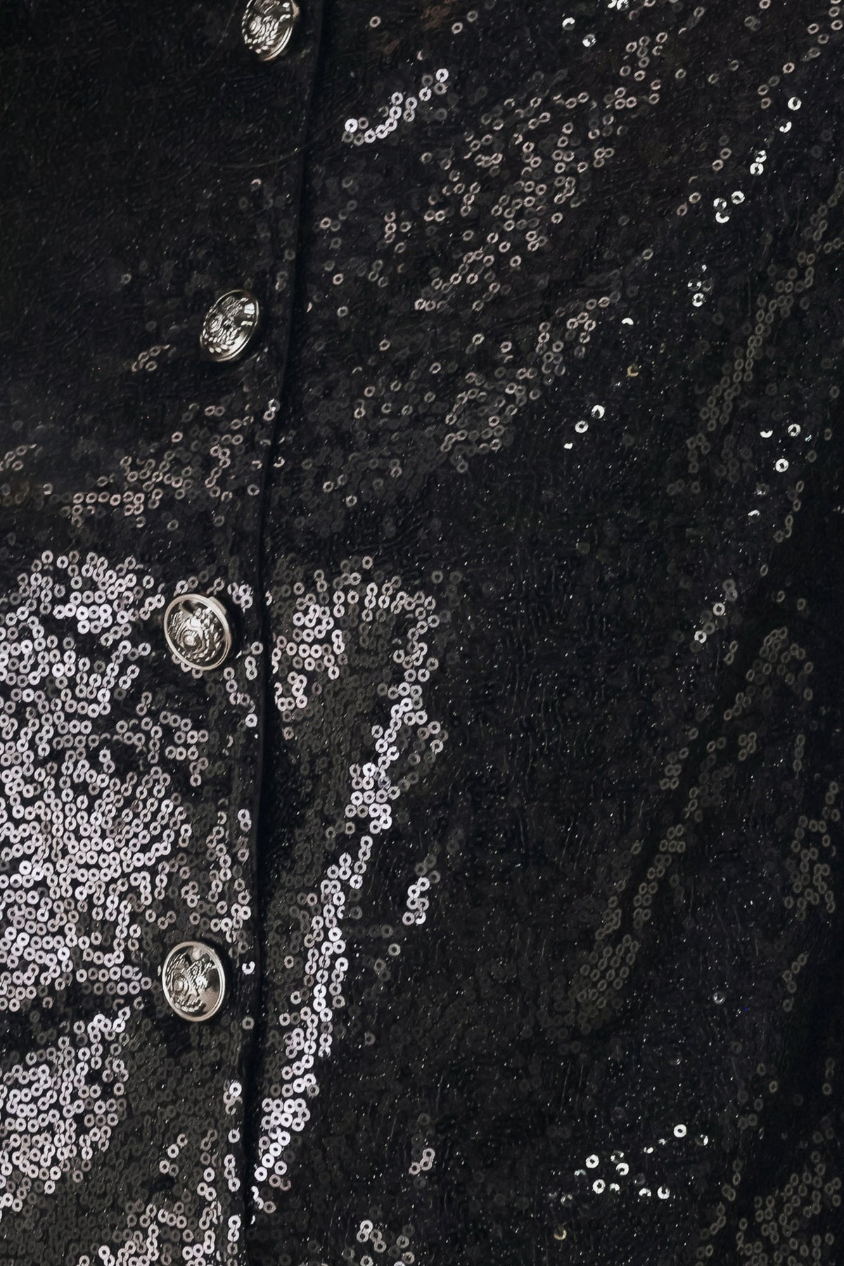 A woman modeling a black long-sleeve cropped jacket covered in sequins, featuring a buttoned front | FREEMARKET