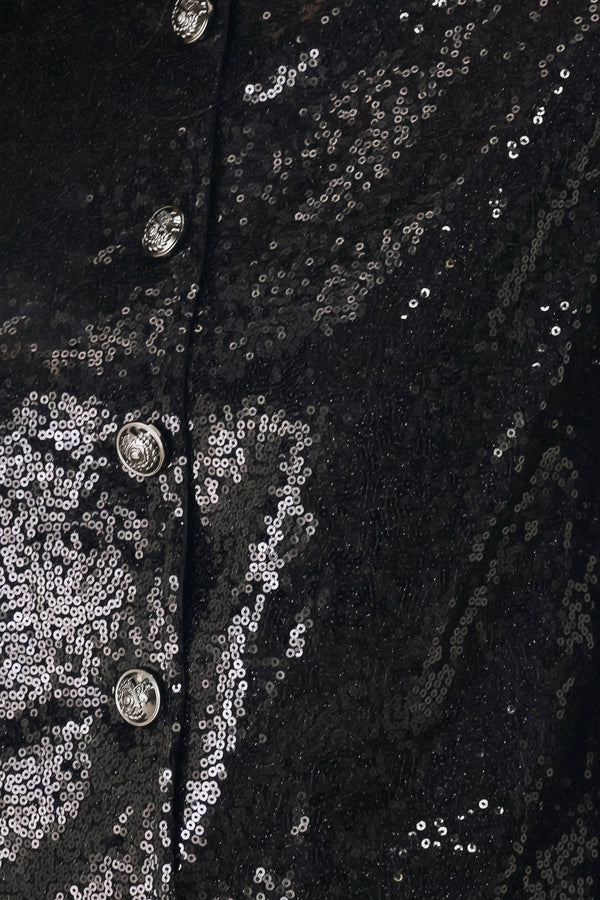 A woman modeling a black long-sleeve cropped jacket covered in sequins, featuring a buttoned front | FREEMARKET