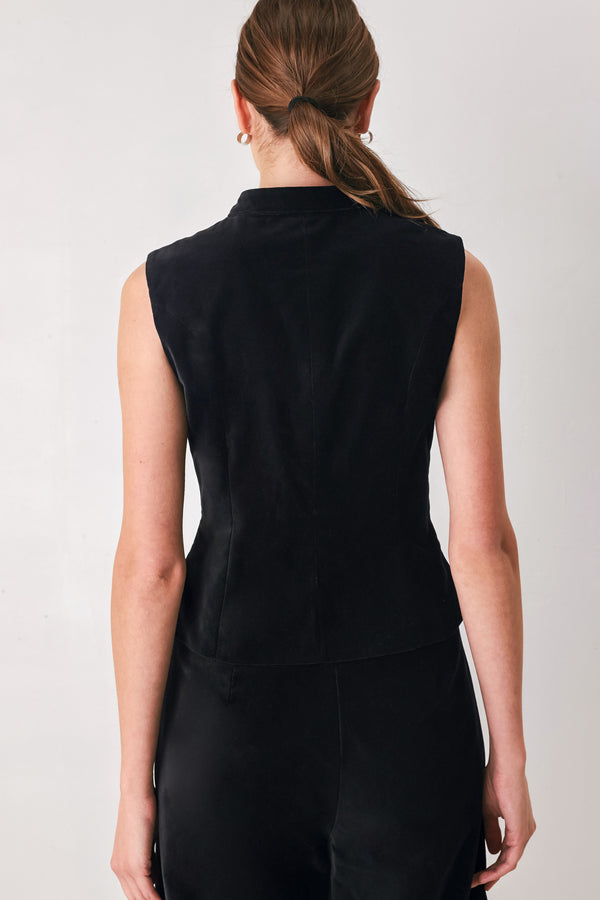 Model wearing a black velvet mandarin neck vest with military style stitching | FREEMARKET