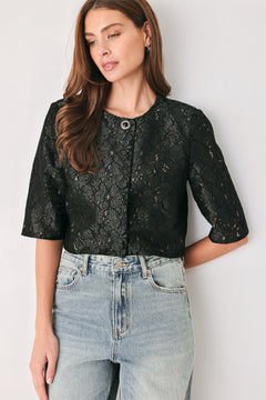 A woman wearing a black lace short-sleeve cropped top with a single button closure | FREEMARKET